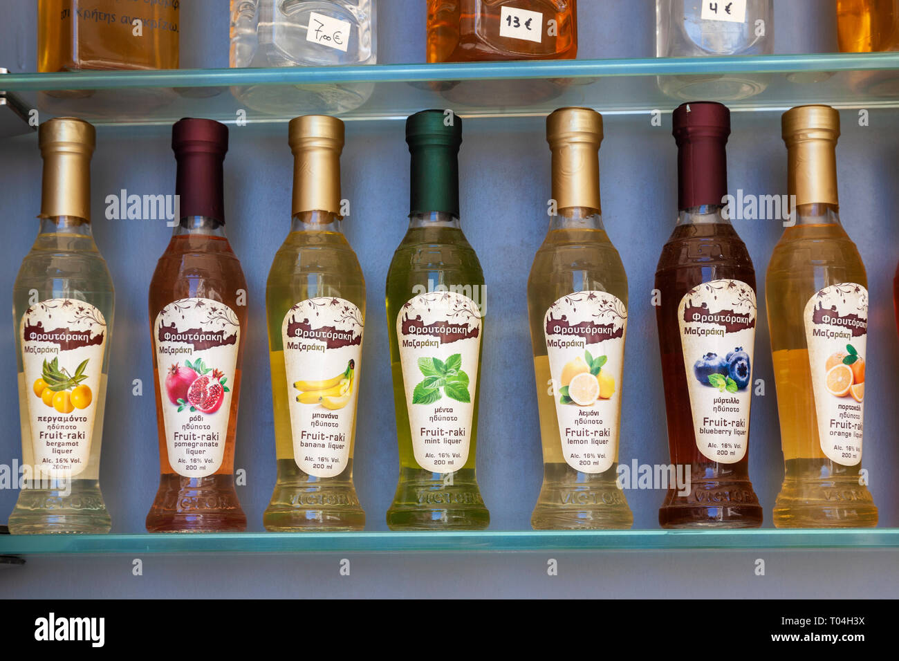 Close up of bottles of different varieties of Fruit - Raki Liqueur for sale in Chania, Crete, Greece Stock Photo