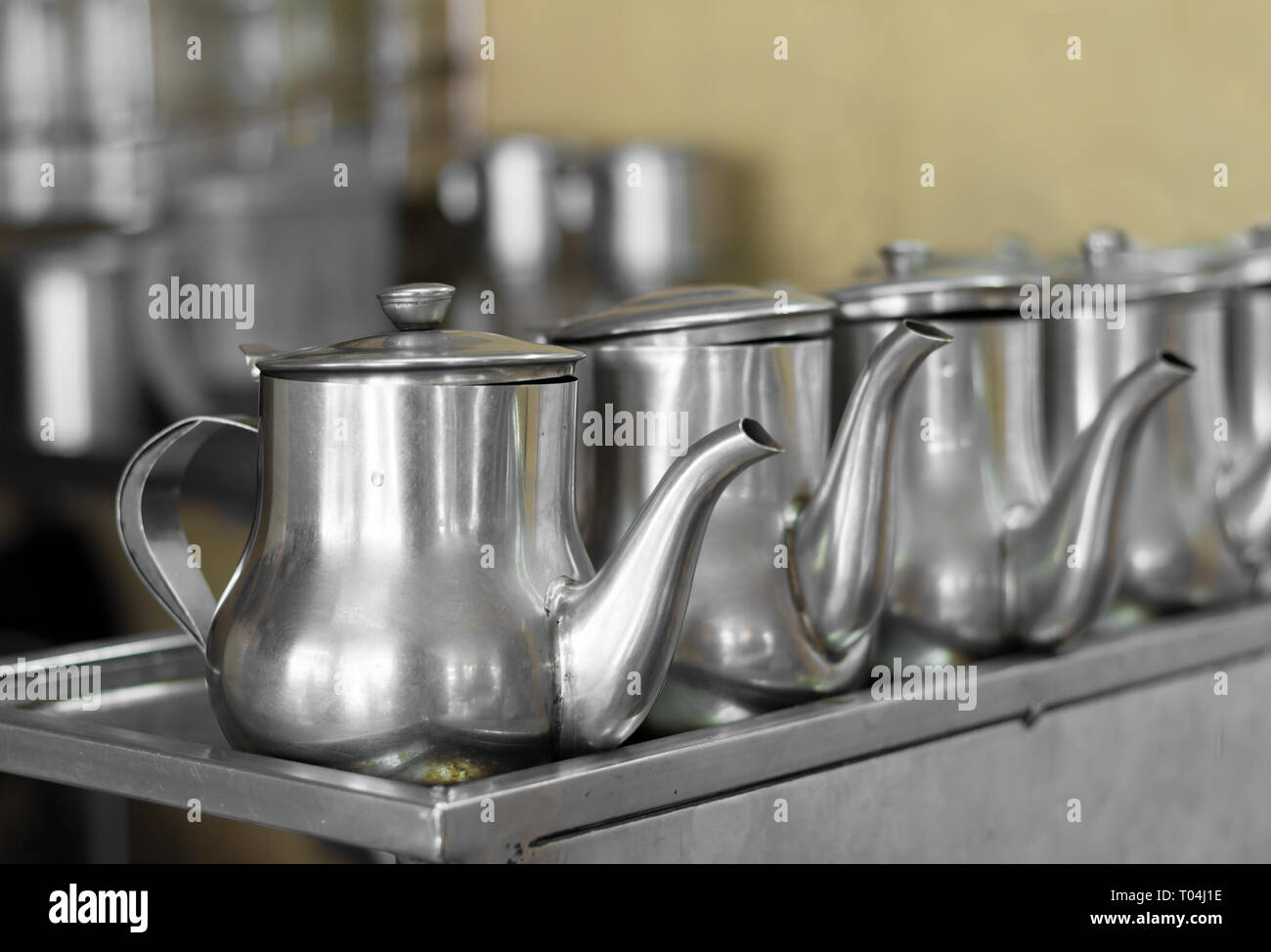 line of identical stainless steel tea pots Stock Photo