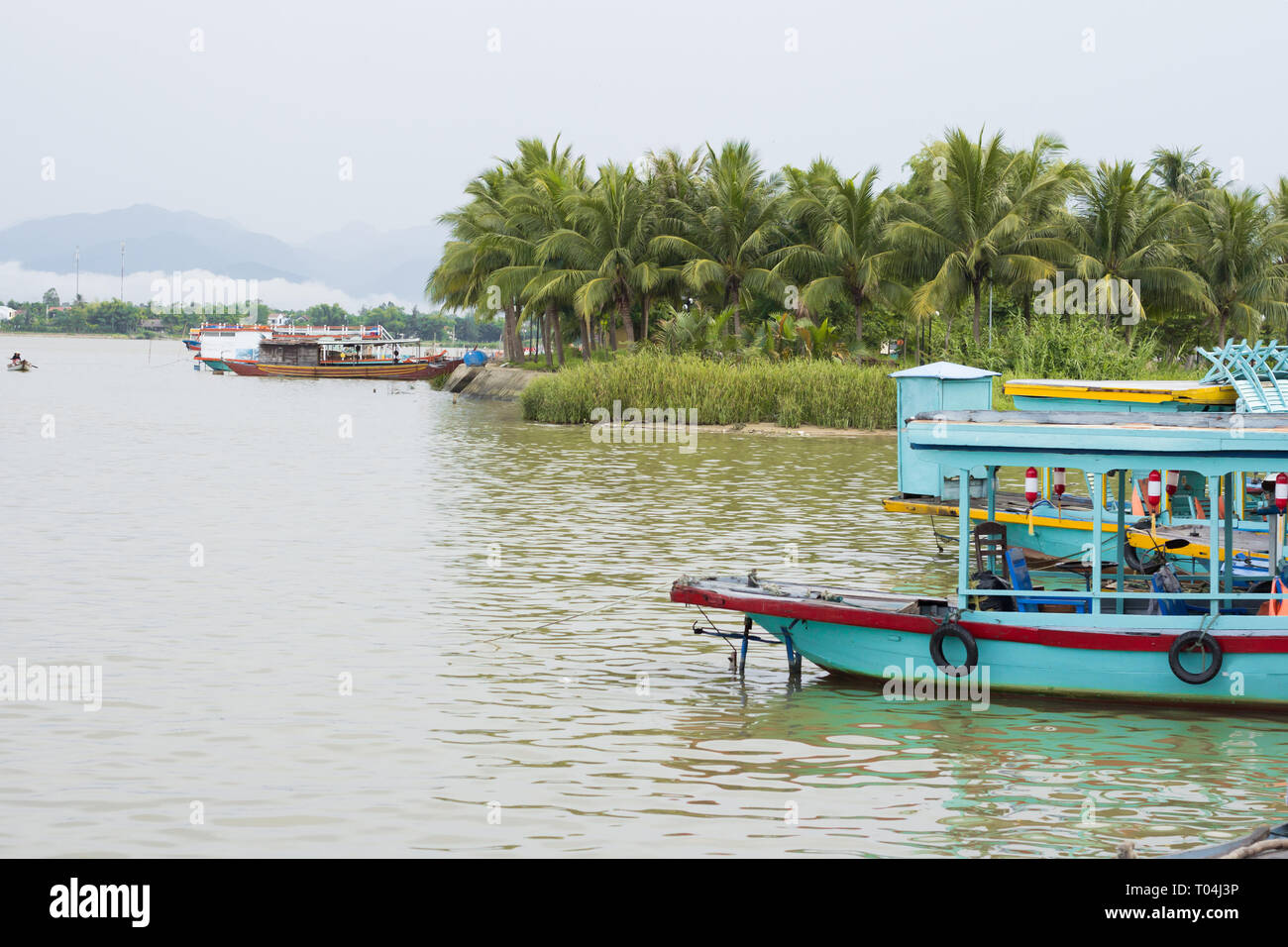 boat on river in Vietnam heading to port Stock Photo