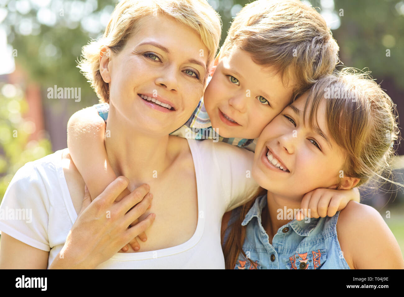 portrait of a family outdoors. mom with children in the summer. Mother and kids Stock Photo