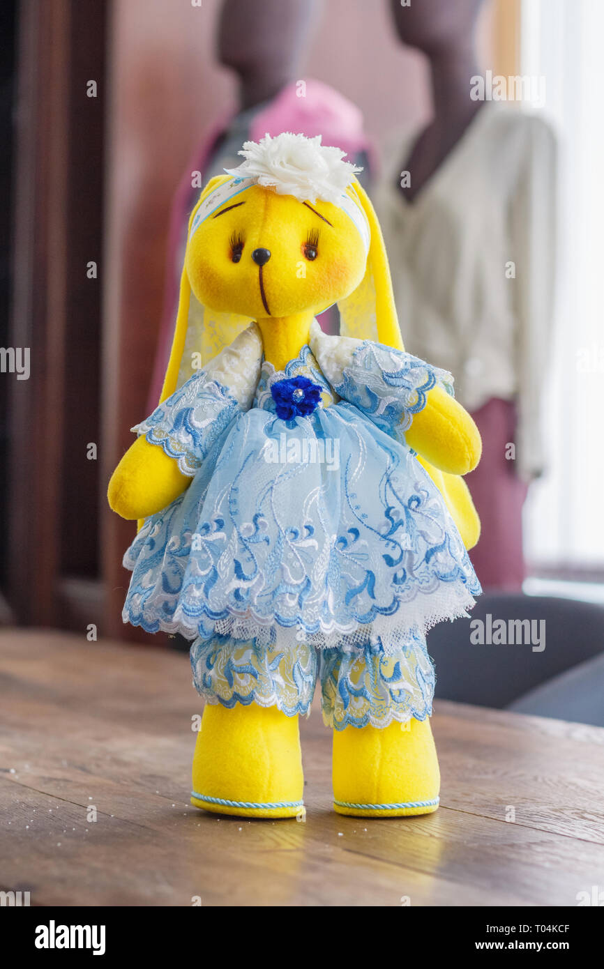 Handmade doll yellow bunny in a blue dress Stock Photo - Alamy