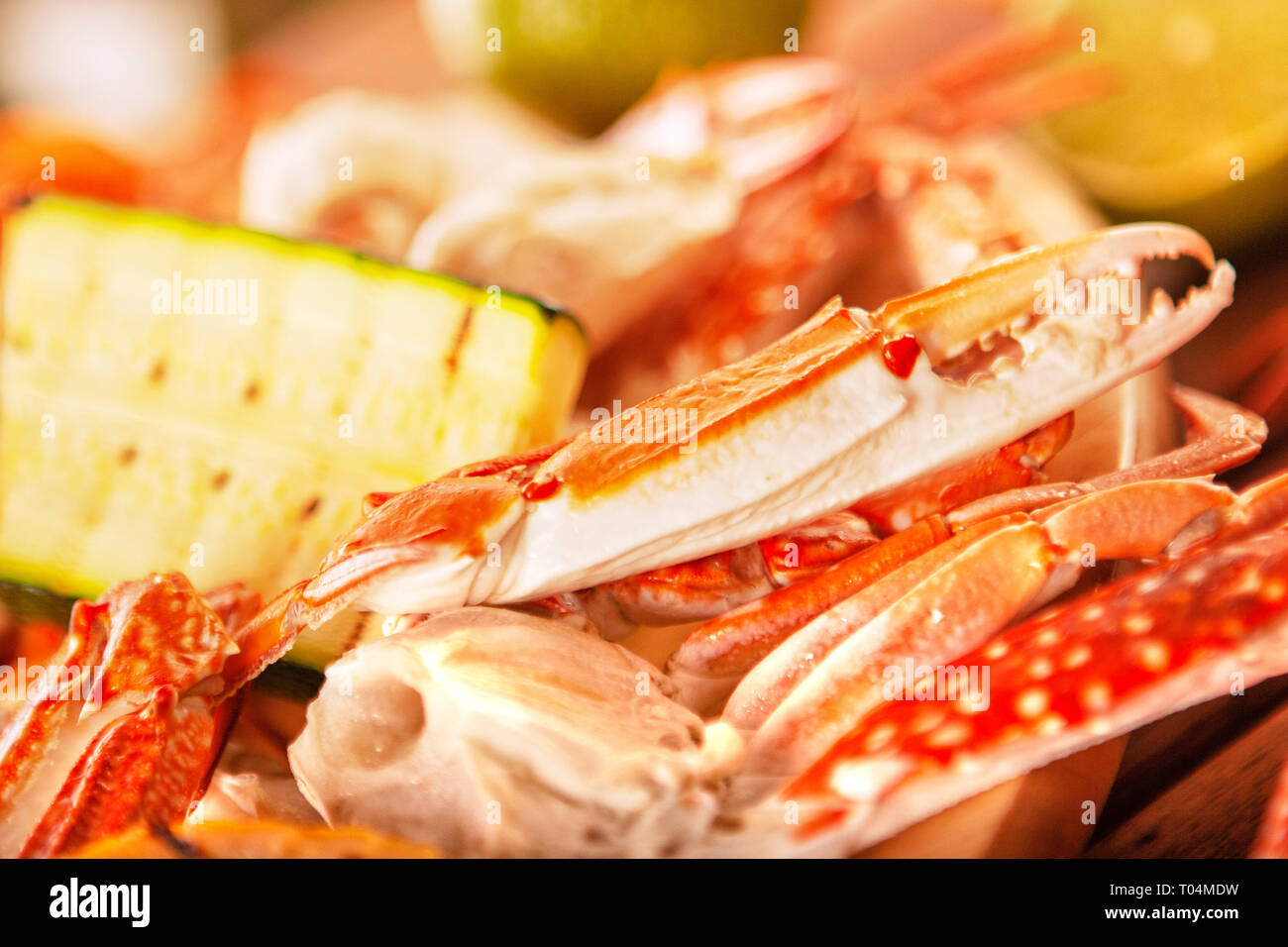 Blue grilled crabs with vegetables on wooden table Stock Photo