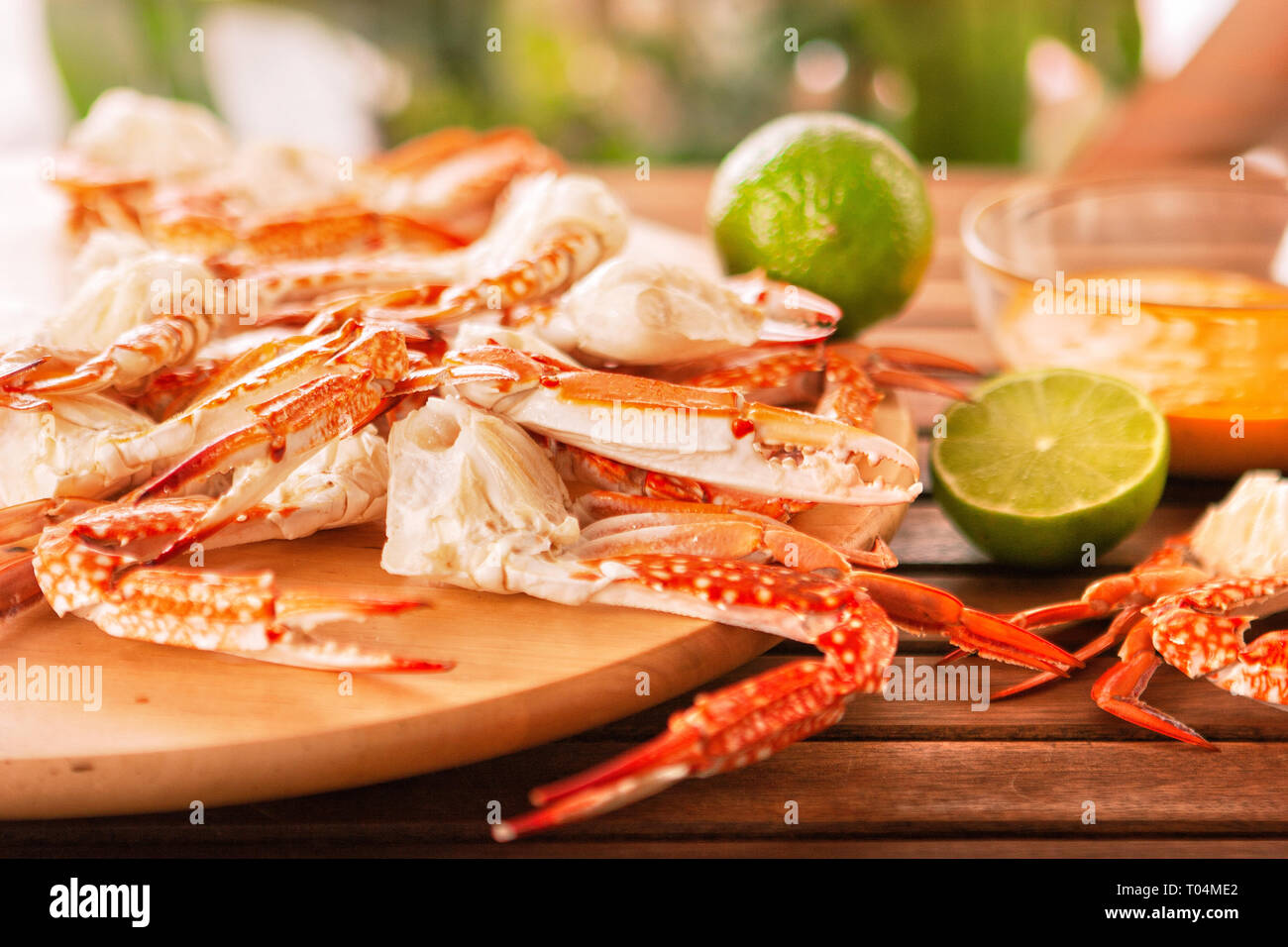 Blue grilled crabs with vegetables on wooden table Stock Photo