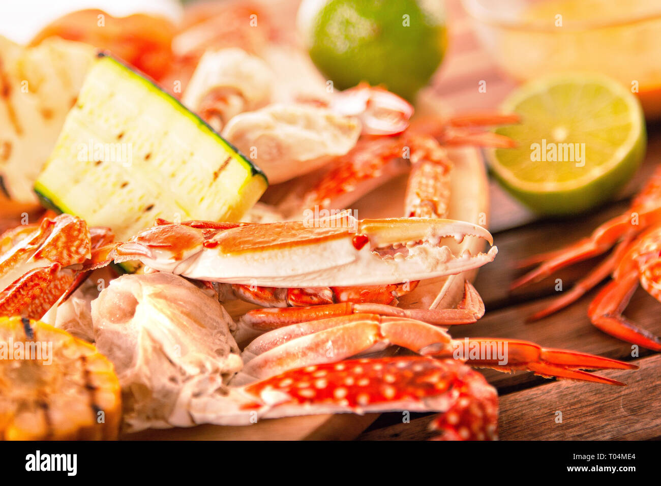 Blue grilled crabs with vegetables on wooden table Stock Photo