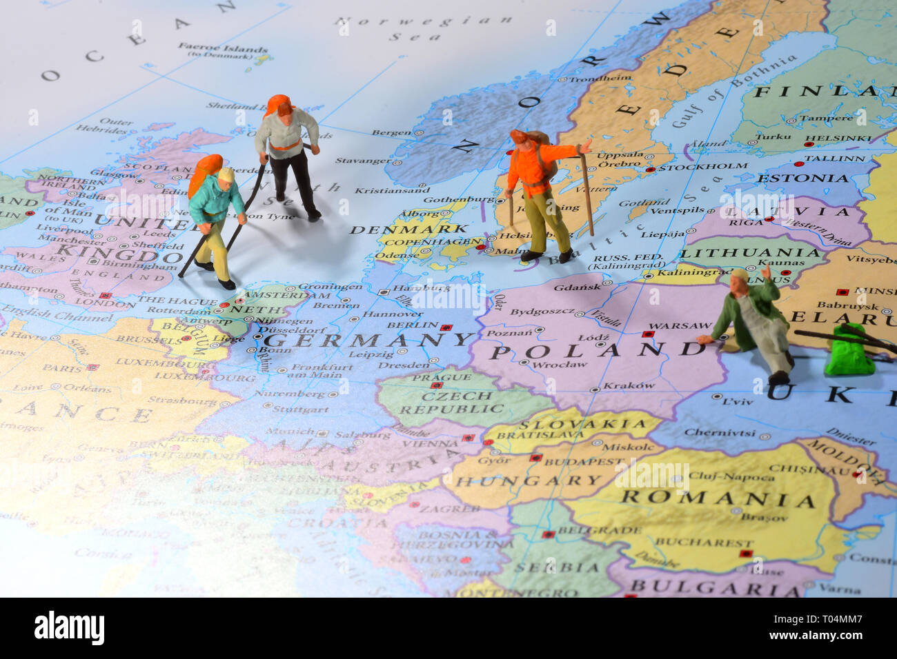 Miniature figures trekking back to Europe Stock Photo