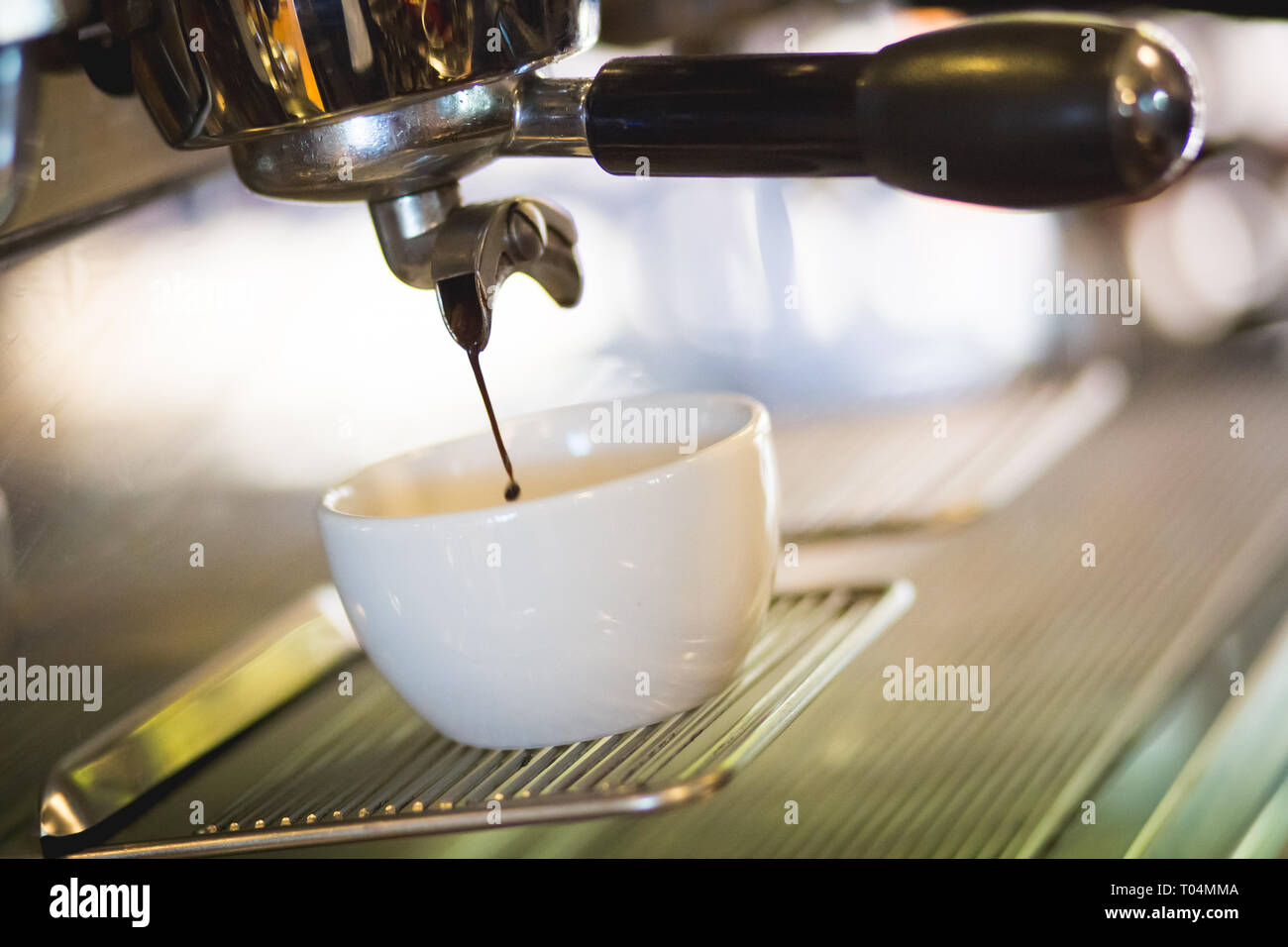 coffee machine dripping in to coffee cup Stock Photo Alamy