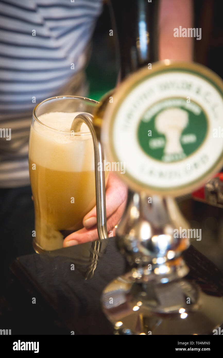 Pouring pint of beer from tap Stock Photo