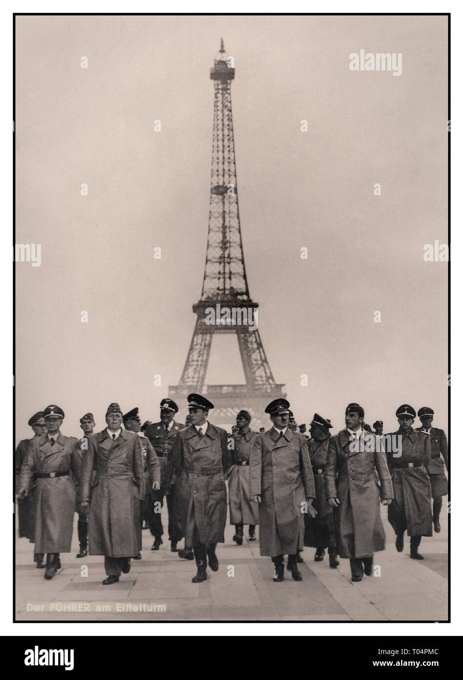 HITLER Eiffel Tower PARIS Adolf Hitler with his group of high ranking Nazi Germany Military Officers including industrial strategist Albert Speer at his right side, in occupied Paris with the Eiffel Tower in background. An iconic carefully arranged Nazi propaganda image with German caption added, of Nazi Germany occupation in France World War II July 1940 WW2 Stock Photo