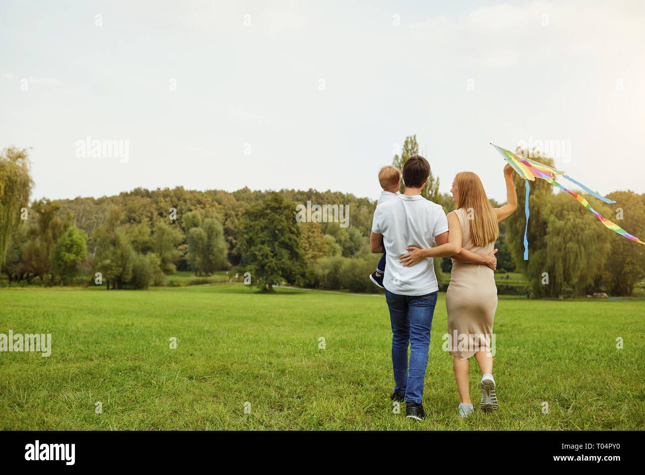 Happy family runs in park hi-res stock photography and images - Alamy