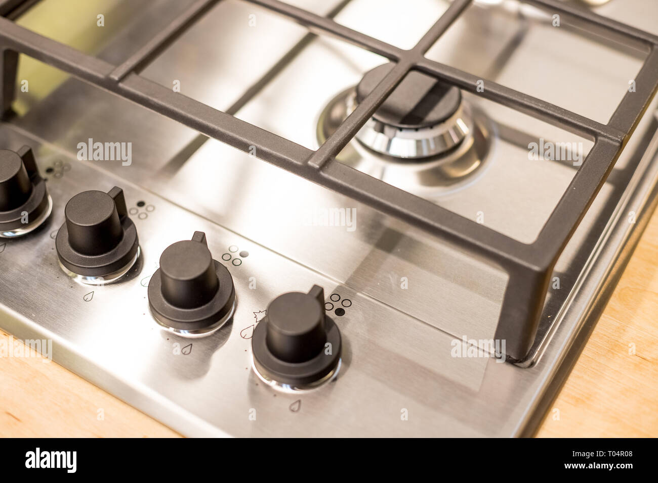 Metal gas stove on modern kitchen. the concept of forced savings on utilities Gas stove.knob heat switch ,elegant metal ,steel black and white.gas Stock Photo
