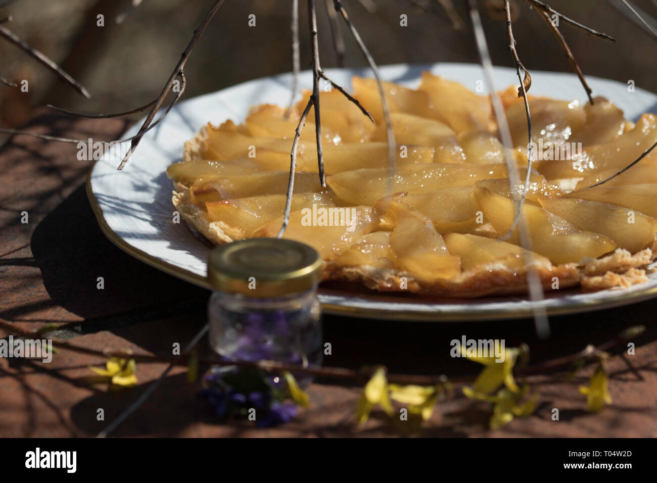 Spring, still life, violet, laburnum,  cake, pear tatin Budapest March 17, 2019 Stock Photo