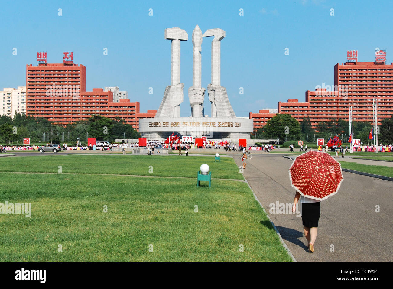 Pyongyang, North Korea - 26 July 2014. Monument to founding of the state party in DPRK capital featuring hammer, Sickle and calligraphy brush. Stock Photo