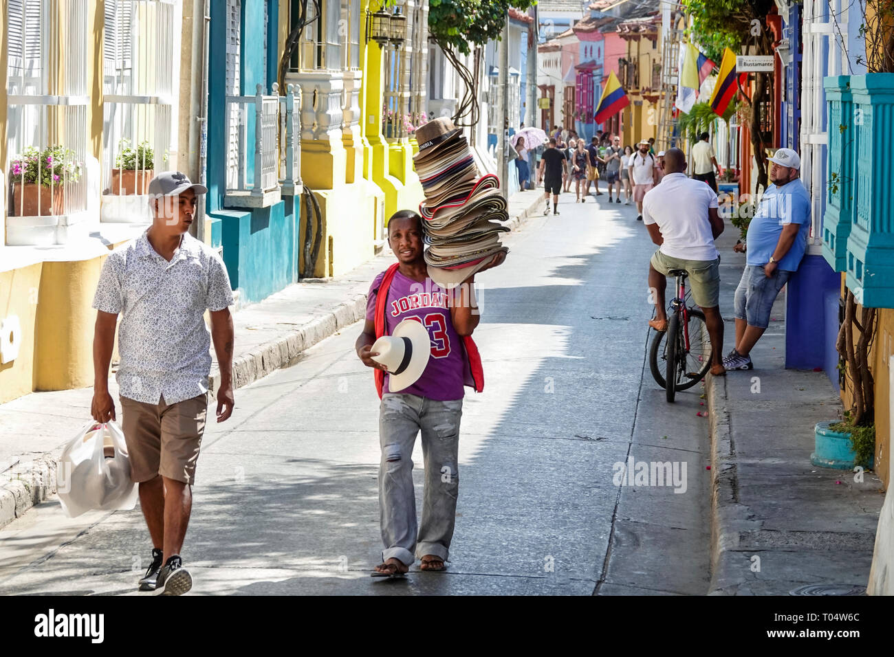 Cartagena Colombia,Center,centre,San Diego,Hispanic resident residents,man men male,colonial homes,colorful facades,hat vendor,Black Afro Caribbean,CO Stock Photo