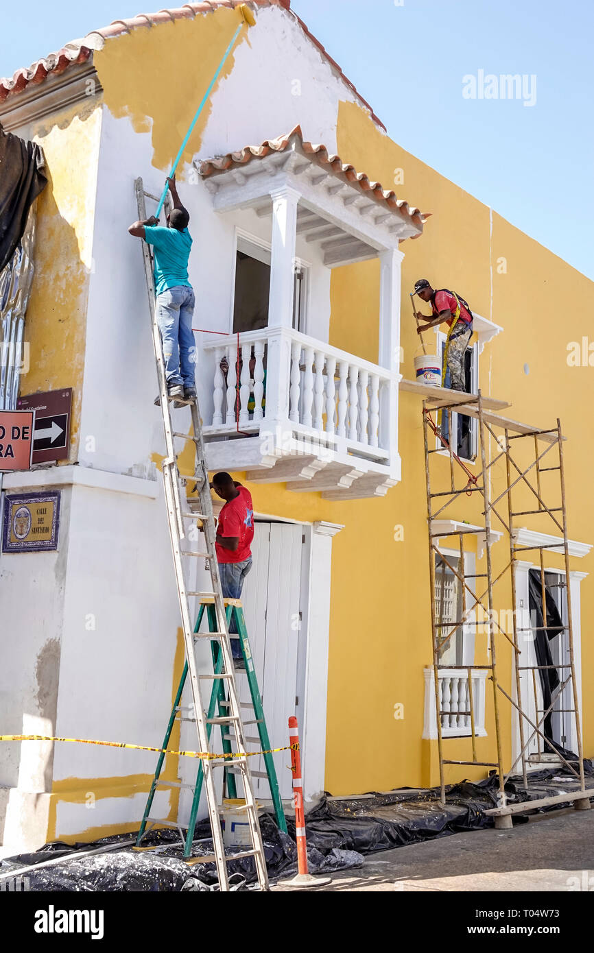 Cartagena Colombia,Center,centre,San Diego,Hispanic resident residents,Afro Caribbean,man men male,workers painters painting building,exterior,ladder, Stock Photo