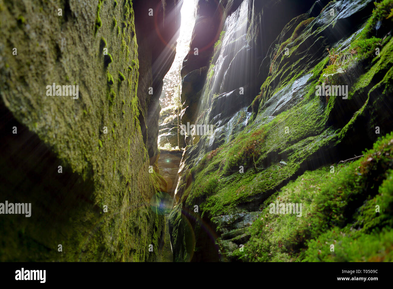 Gap in the rock mountains and rays of light Stock Photo - Alamy
