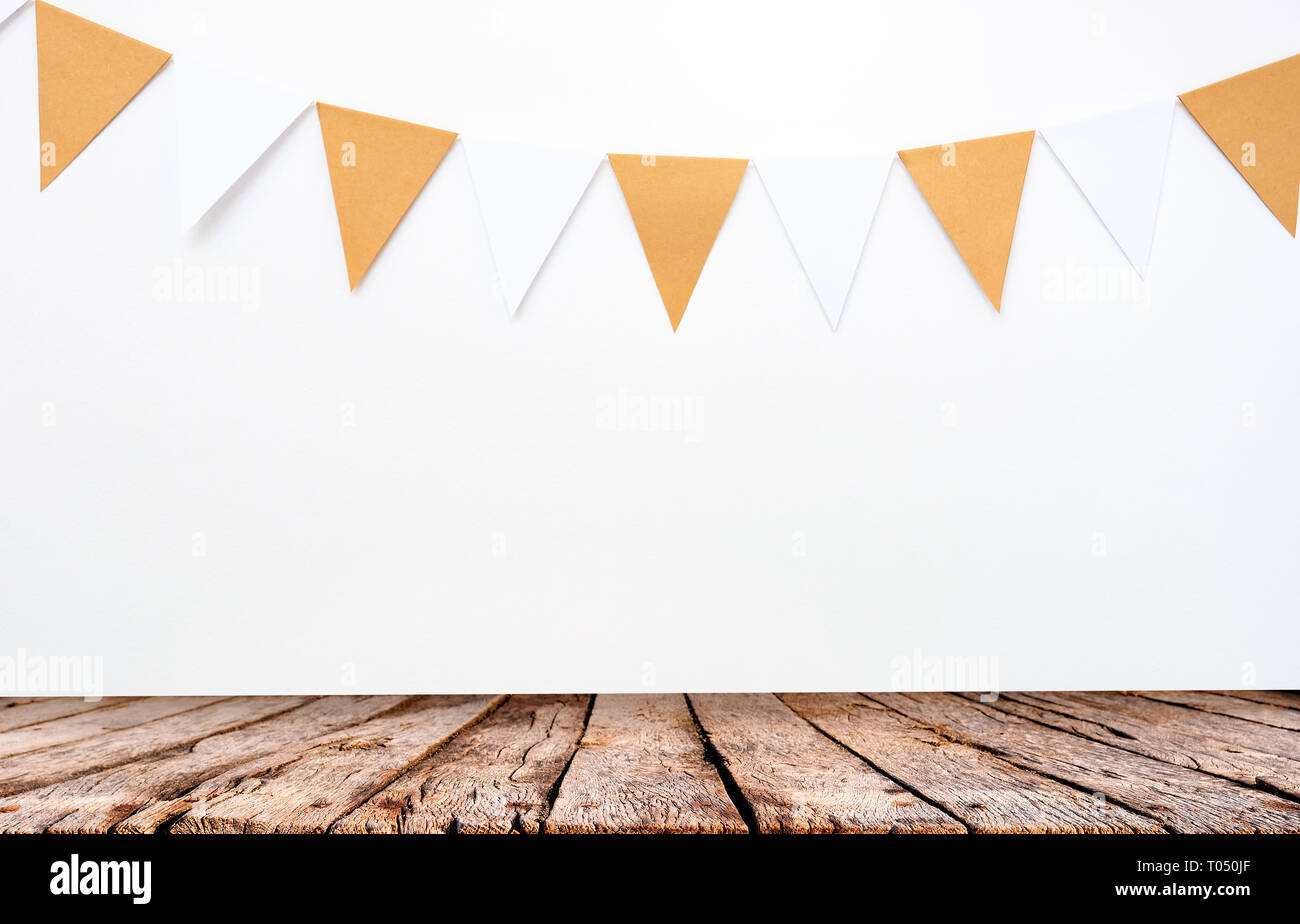 Wooden Table And Hanging Paper Flags On White Wall Background