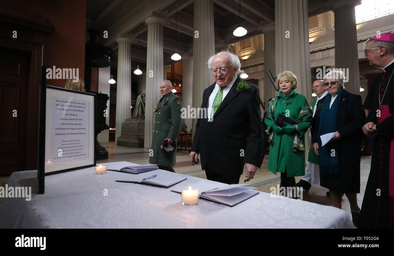 President Michael D Higgins signs a book of condolence before a memorial service for the victims of the New Zealand Mosque attacks at St Marys Pro Cathederal in Dublin. Stock Photo
