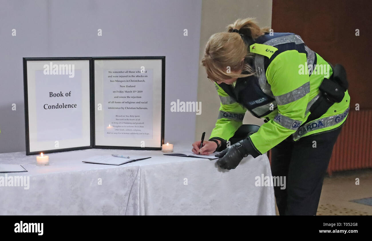 A Gardai signs a book of condolence before a memorial service for the victims of the New Zealand Mosque attacks at St Marys Pro Cathederal in Dublin. Stock Photo