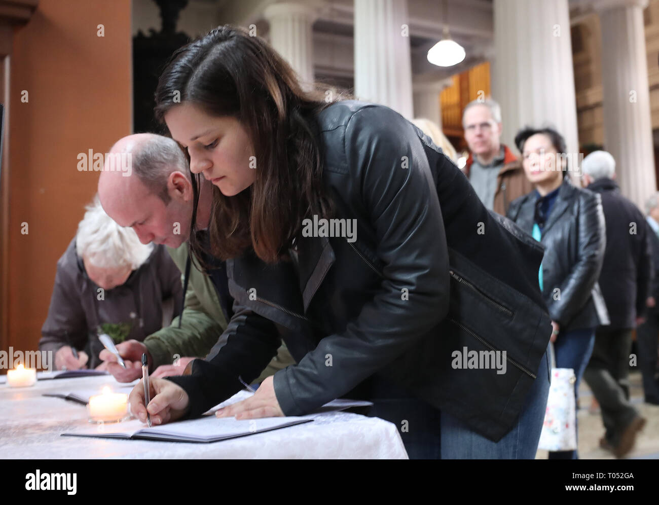 People sign a book of condolence before a memorial service for the victims of the New Zealand Mosque attacks at St Marys Pro Cathederal in Dublin. Stock Photo
