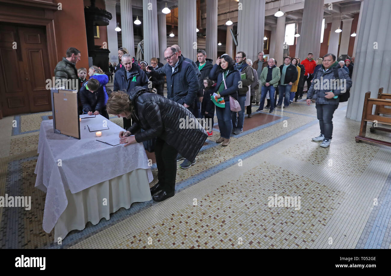 People sign a book of condolence before a memorial service for the victims of the New Zealand Mosque attacks at St Marys Pro Cathederal in Dublin. Stock Photo