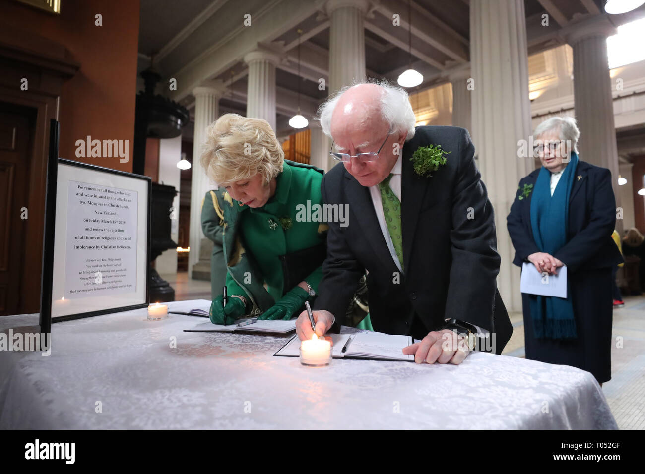 President Michael D Higgins and his wife Sabina sign a book of condolence before a memorial service for the victims of the New Zealand Mosque attacks at St Marys Pro Cathederal in Dublin. Stock Photo