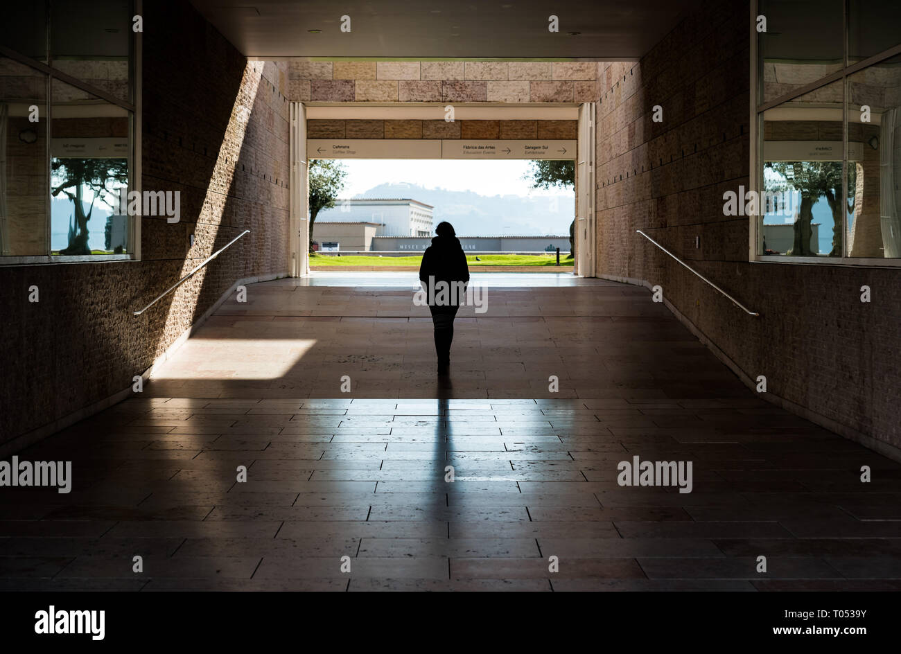 Belem, Lisbon / Portugal - 12 28 2018: Young white woman with small backpack walking through the museum of contemporary art Stock Photo