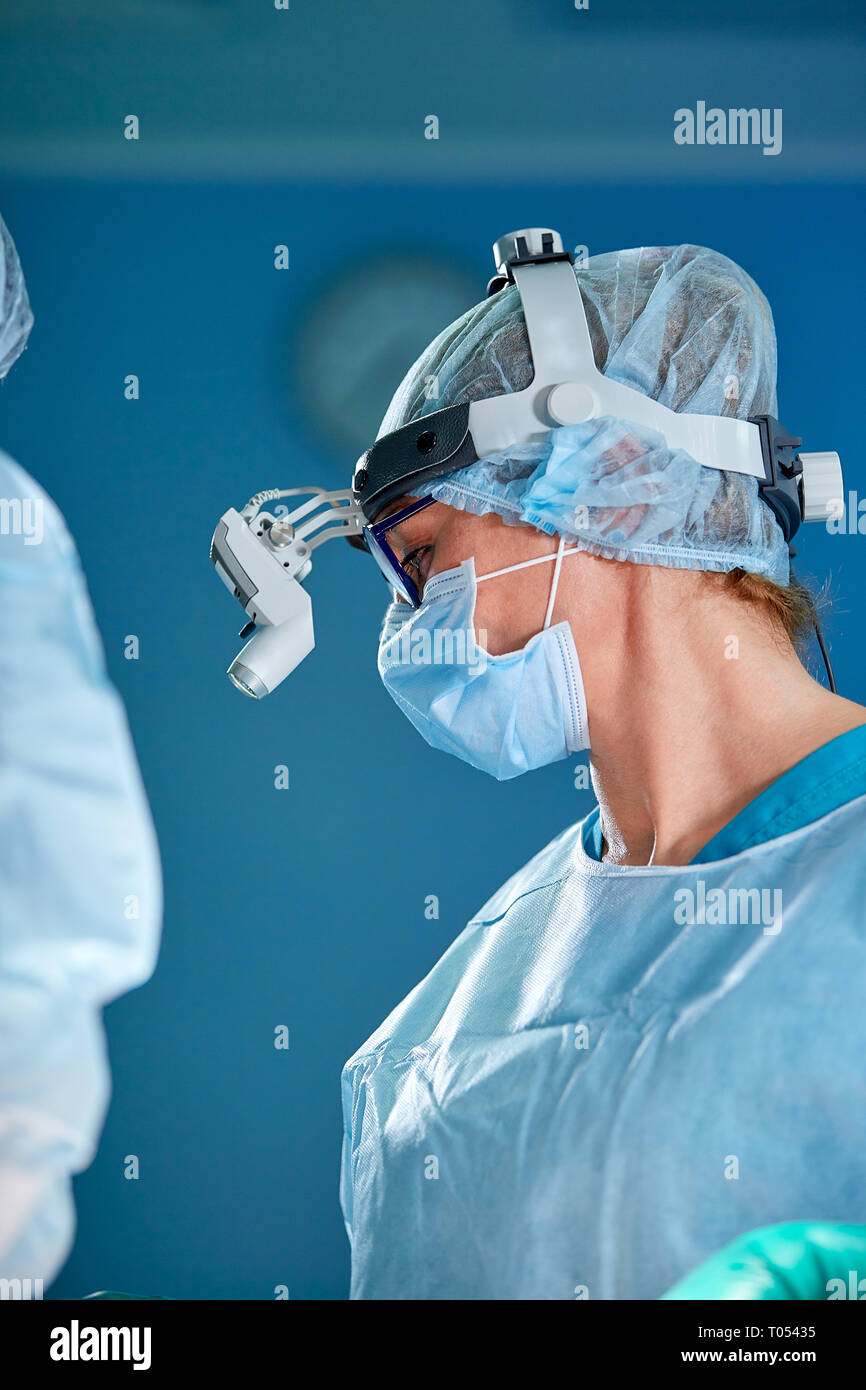 Close up portrait of female surgeon doctor wearing protective mask and ...