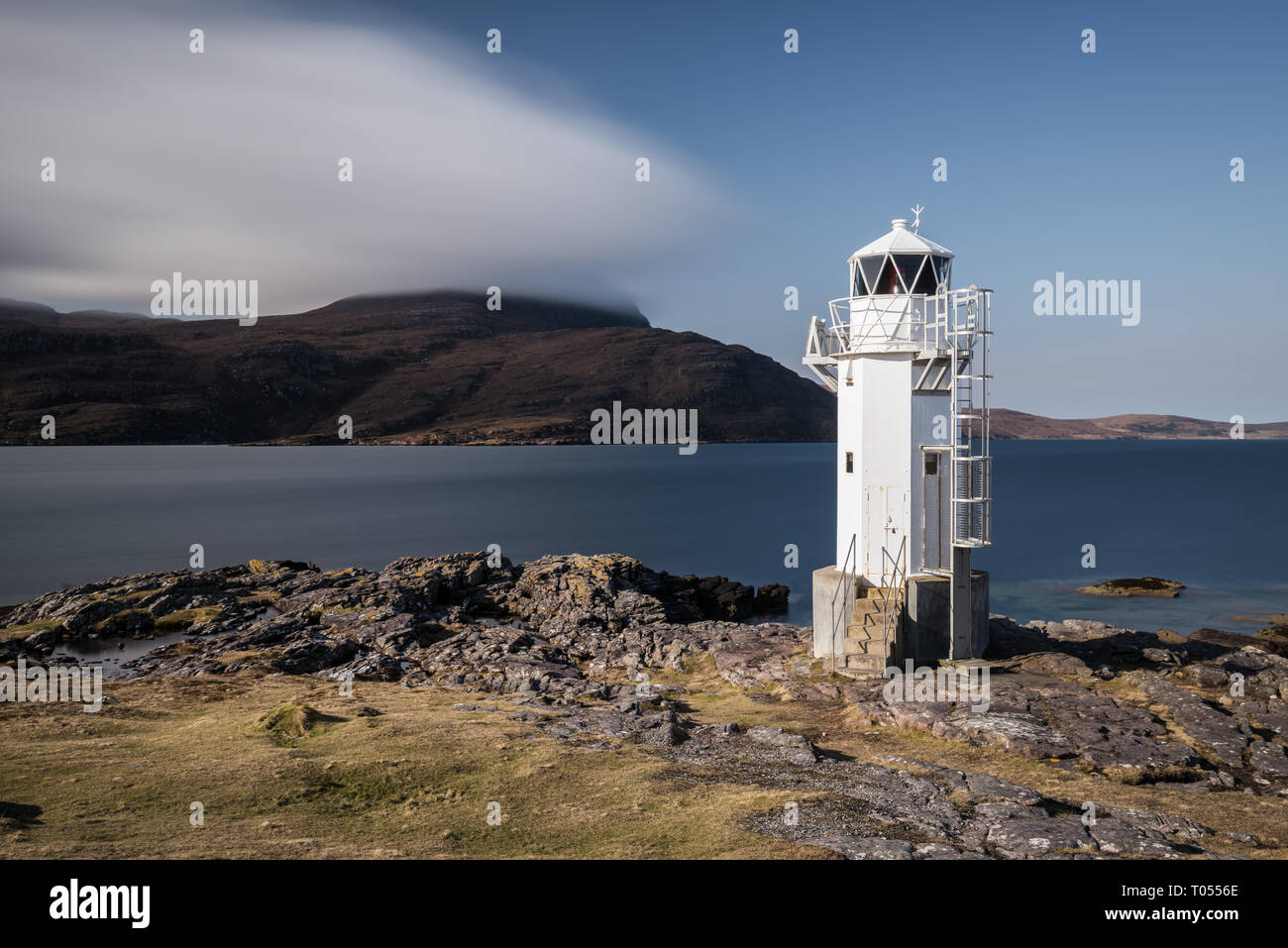 A long exposure of Rhua lighthouse on a sunny day with the sea behind it, Sutherland, Scotland, UK Stock Photo