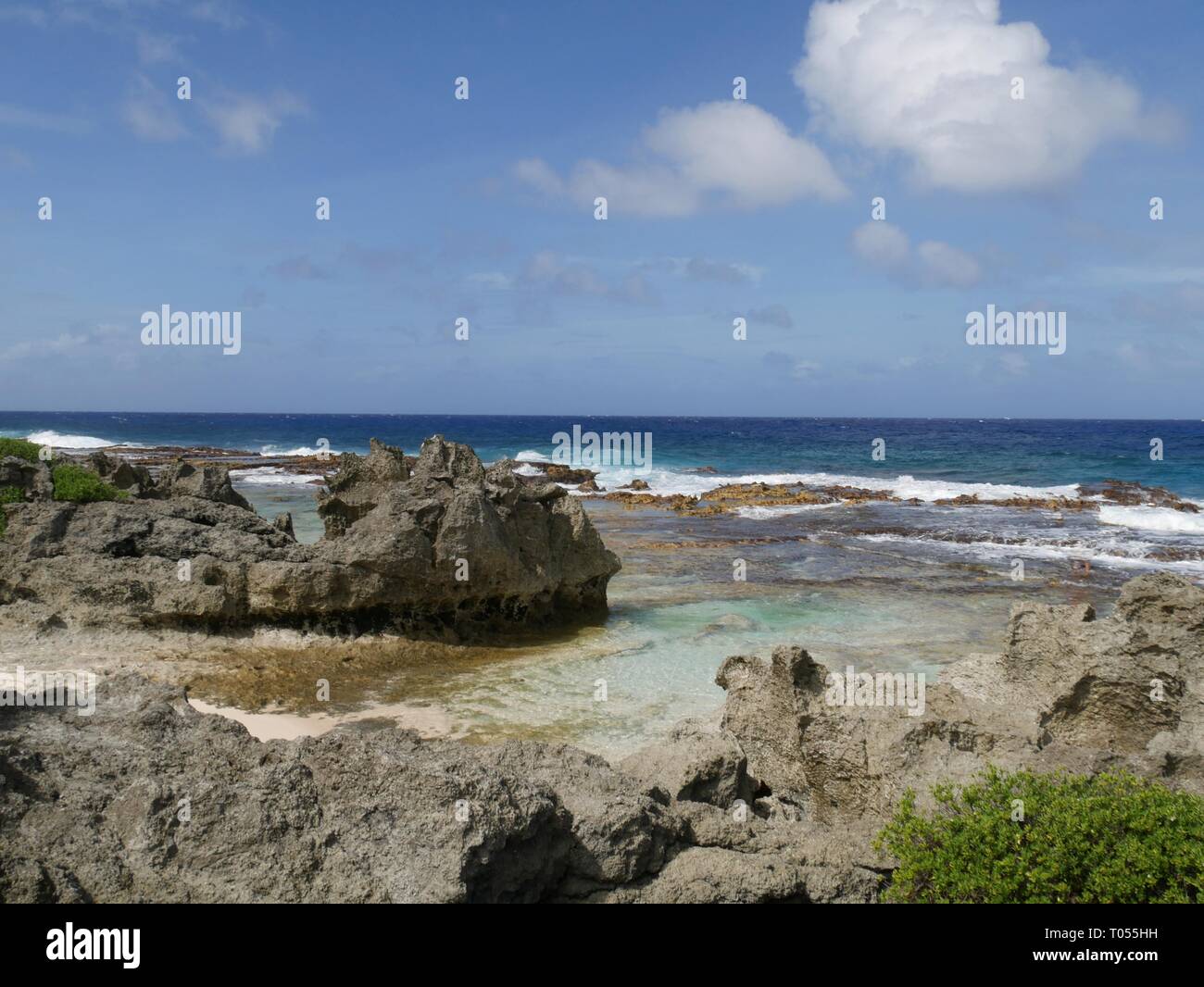 Scenic coastal view with rocks and corals bordering a beach in the ...