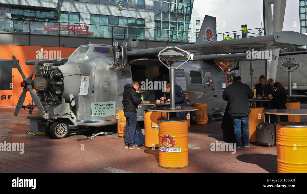 MUNICH AIRPORT, BAVARIA, GERMANY - MARCH 13, 2019: Street food from a themed truck at the airport. Smokey Joe's vintage style airplane food truck. Stock Photo