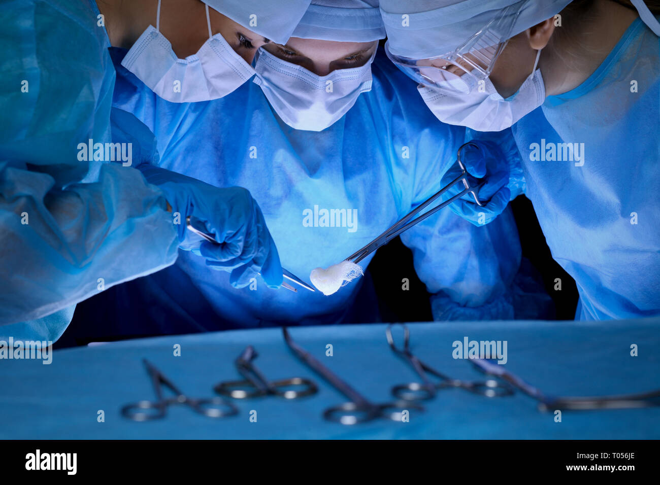 Group of surgeons in masks performing operation. Medicine, surgery and ...