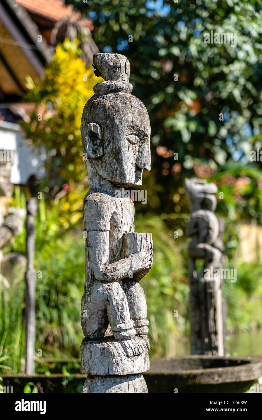 Balinese ancient wooden statue on street in Ubud, island Bali, Indonesia.  These figures of the gods protect the house from evil spirits. Close up  Stock Photo - Alamy