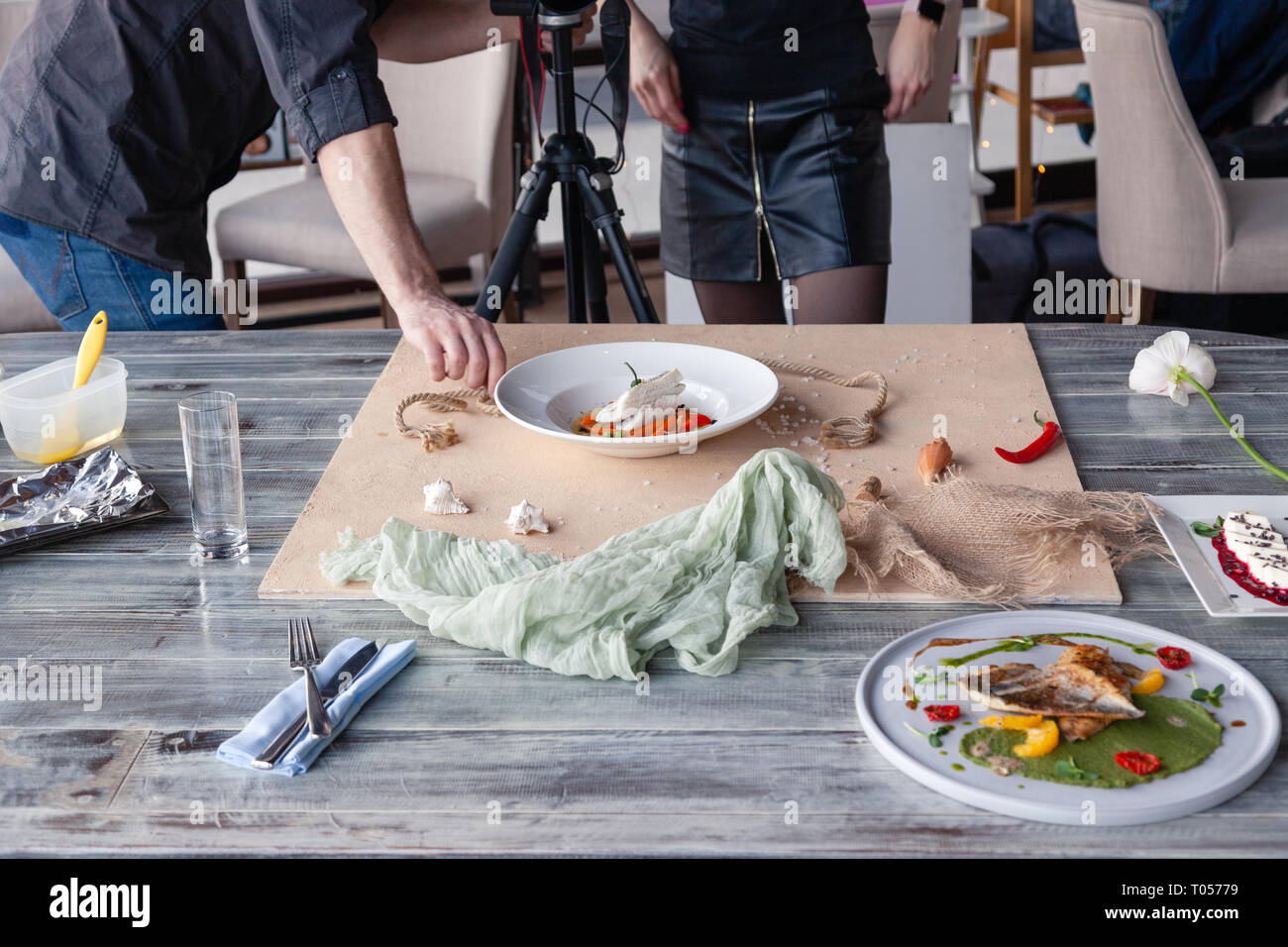 Food Stylist Decorate Preparing To Shoot Fish Dishes With Green