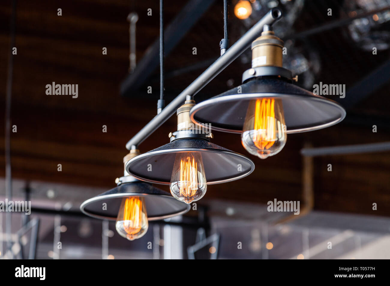 Black iron loft chandeliers with edison lamps on a black