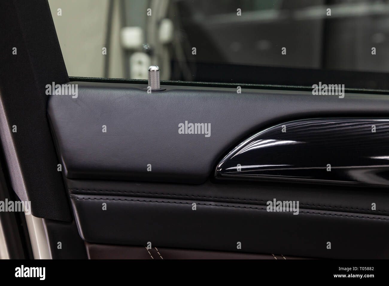 A closeup view of a part of the interior of a modern luxury car with a