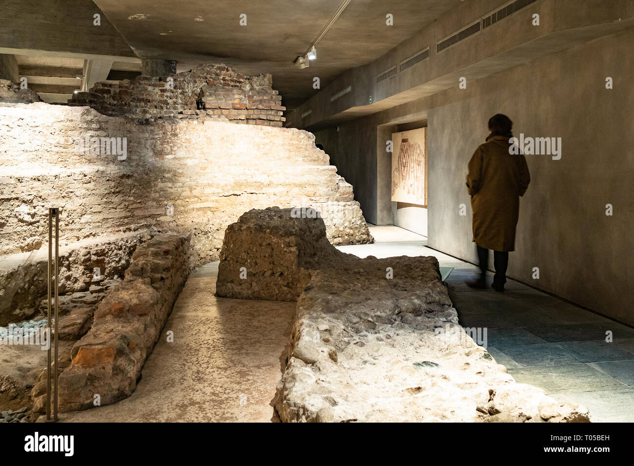MILAN, ITALY - FEBRUARY 24, 2019: woman in archaeological area of ruined ancient baptistery and church of San Giovanni alle Fonti and Santa Tecla in c Stock Photo