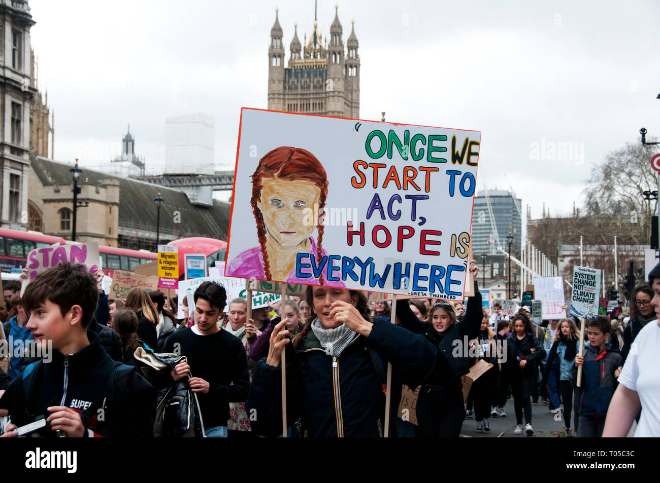 London. School students strike for climate change , part of a global action. A protester holds a painting of nobel-nominated Greta Thunberg with a quo Stock Photo