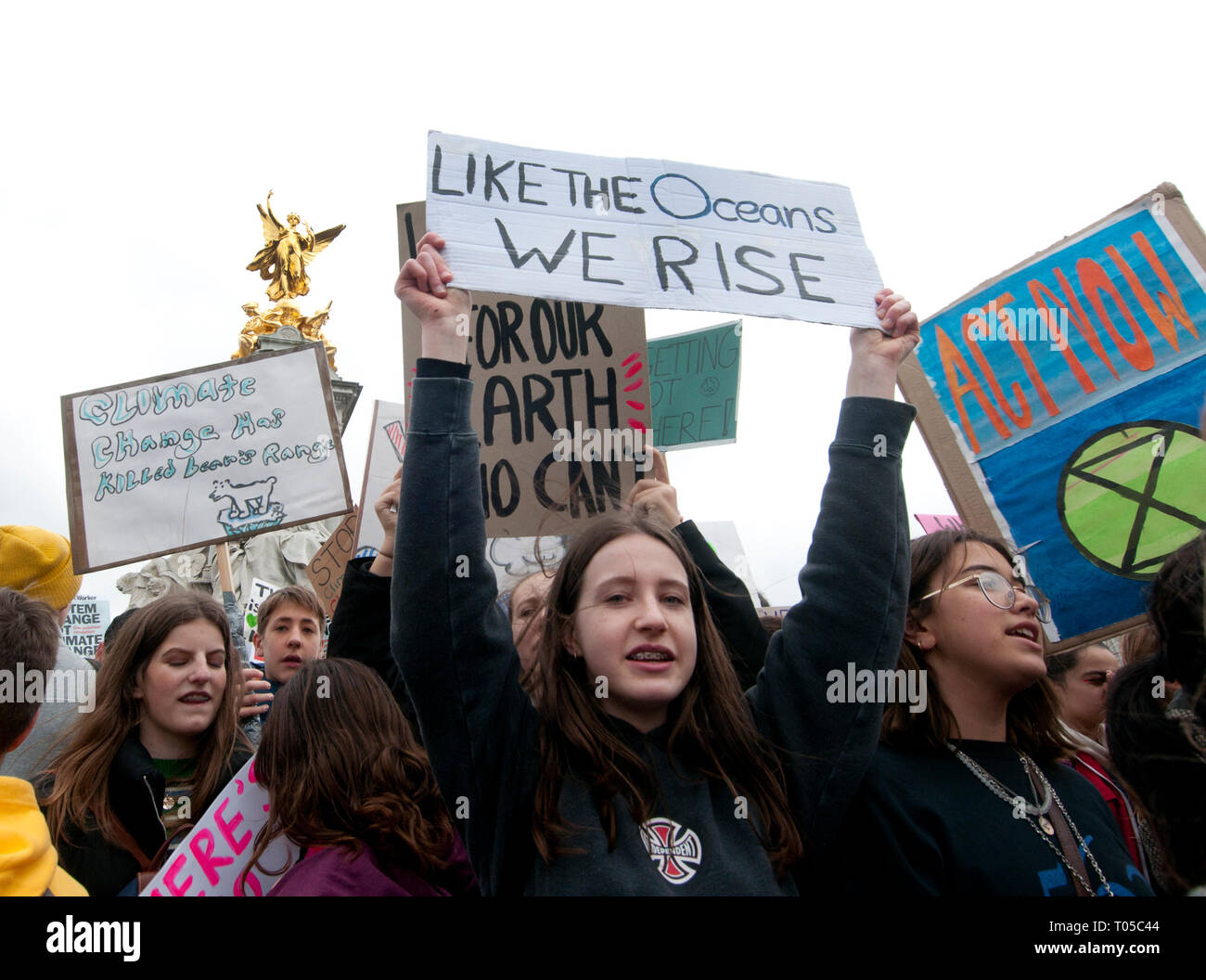 London. School students strike for climate change , part of a global action. A group take over the Victoria statue in front of Buckingham Palace. Stock Photo