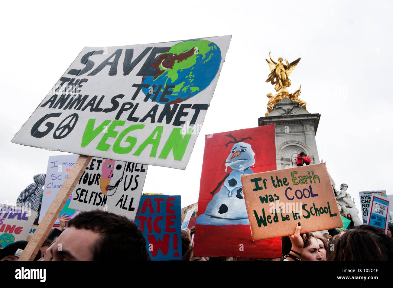 London. School students strike for climate change , part of a global action. A group take over the Victoria statue in front of Buckingham Palace. Stock Photo