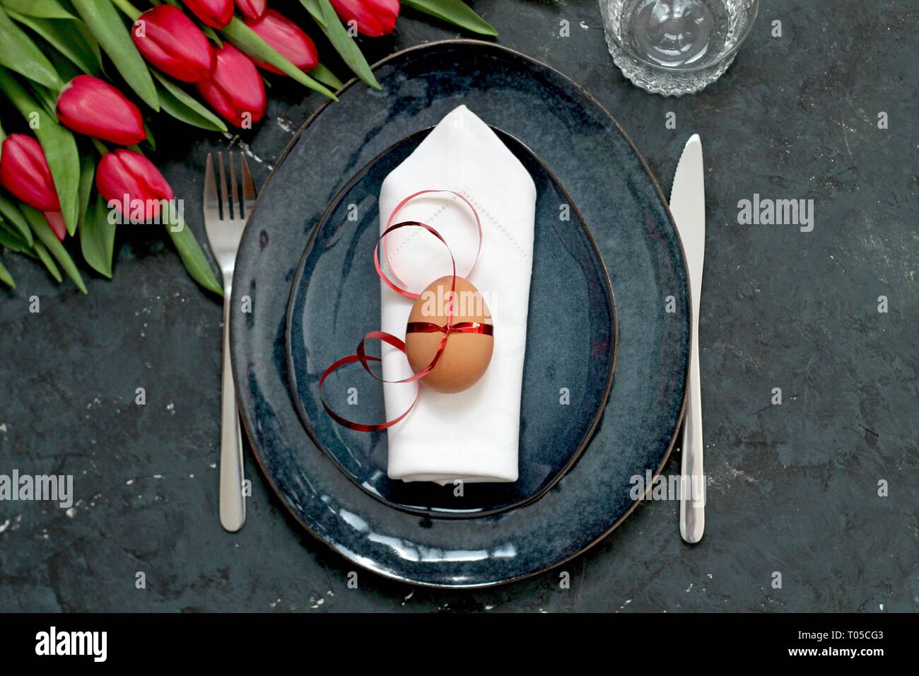 Beautiful festive table with flowers setting for Easter. Holidays background. Top view. Stock Photo