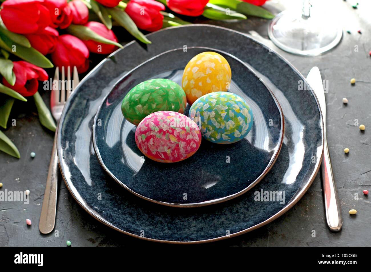 Beautiful festive table with flowers setting for Easter. Holidays background. Top view. Stock Photo