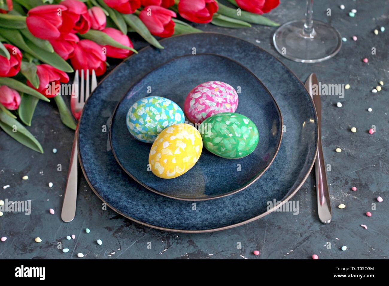 Beautiful festive table with flowers setting for Easter. Holidays background. Top view. Stock Photo