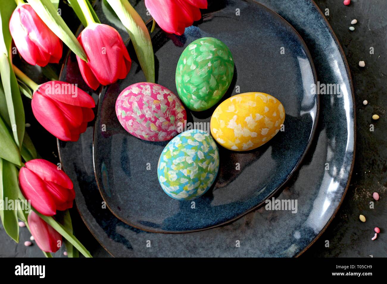 Beautiful festive table with flowers setting for Easter. Holidays background. Top view. Stock Photo