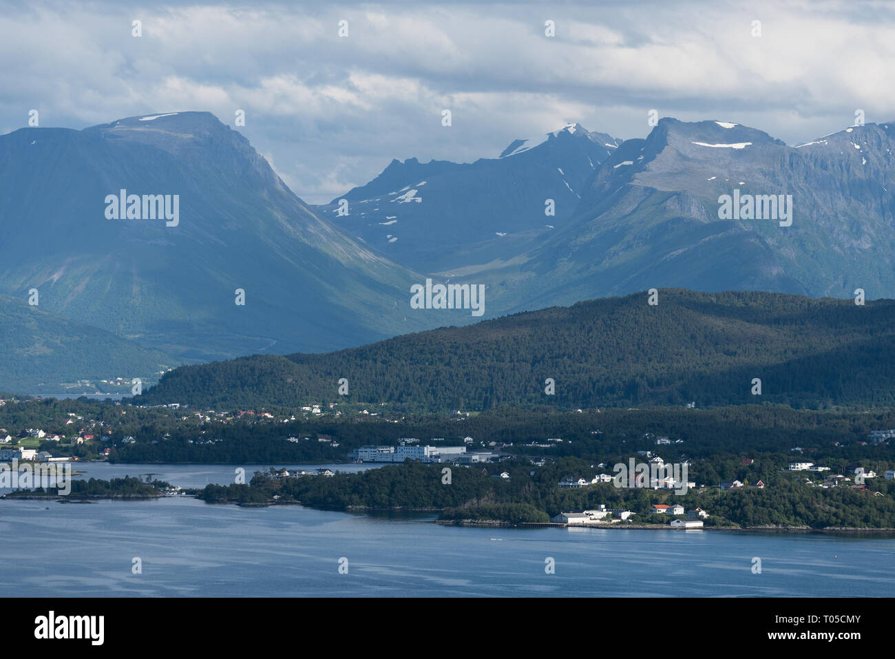 Norwegian landscape in summer. View from the mountain Aksla in the city of Alesund to the mountains of Skopphornet and Hundatinden, as well as the vil Stock Photo