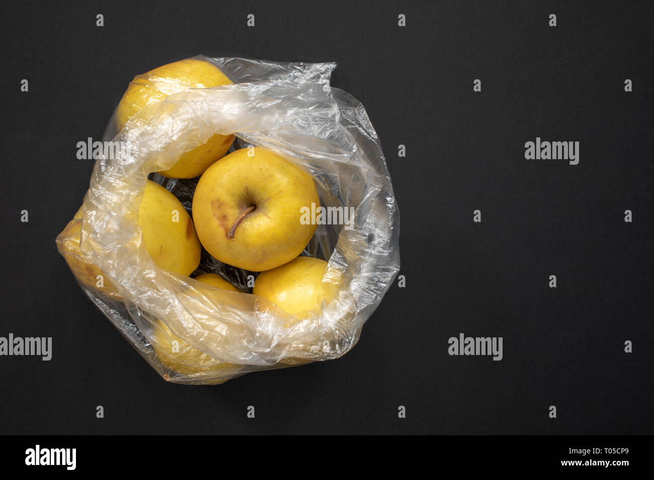 Download Yellow Ripe Apples In Opened Plastic Bag On Grey Background Stock Photo Alamy Yellowimages Mockups