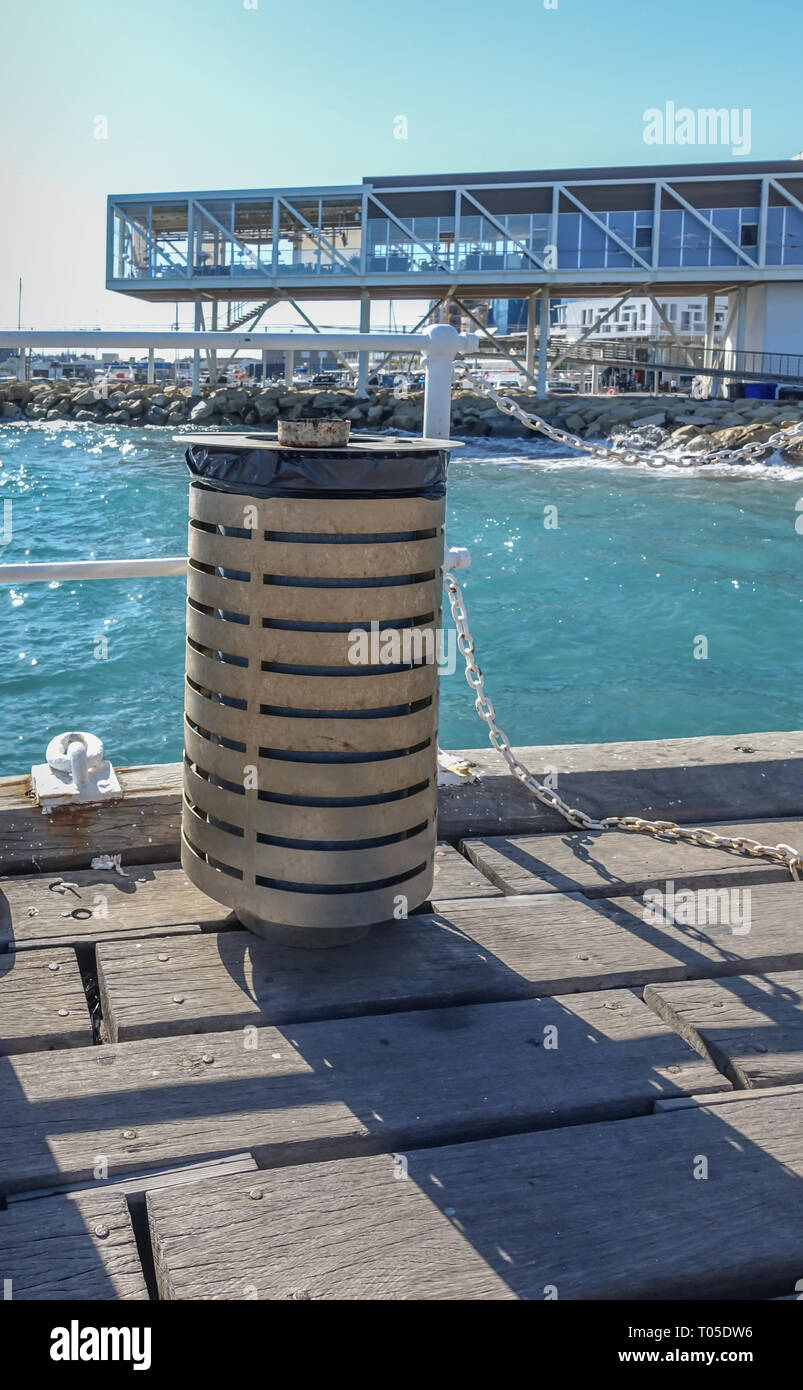 Limassol Port, Limassol, Cyprus - October 31, 2018: Modern rubbish bin with water and new restaurants in the background. Stock Photo