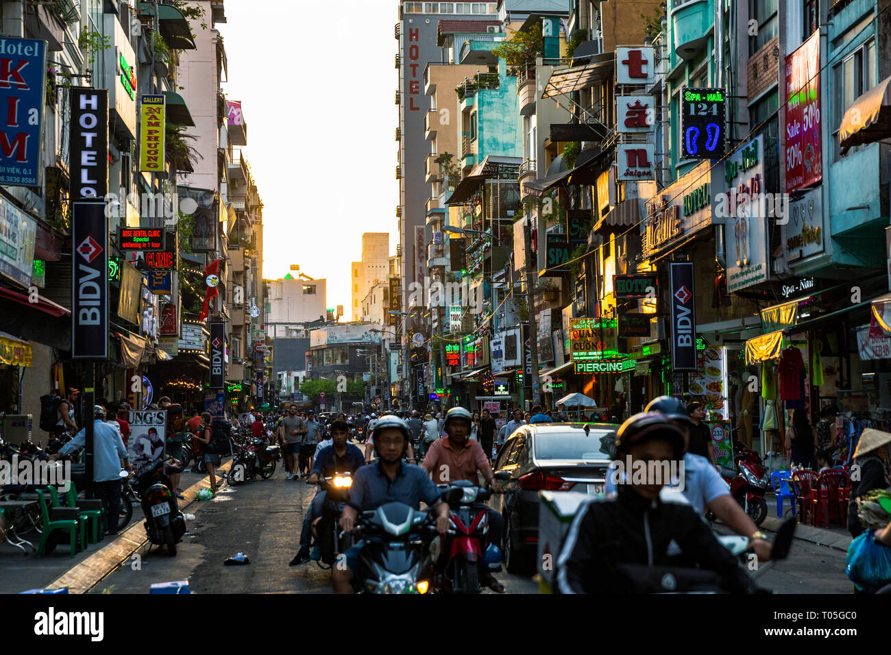 Ho Chi Minh City, Saigon, Vietnam. Sun is setting in the background in the  busy streets in Pham Ngu Lao, Backpacker District Stock Photo - Alamy