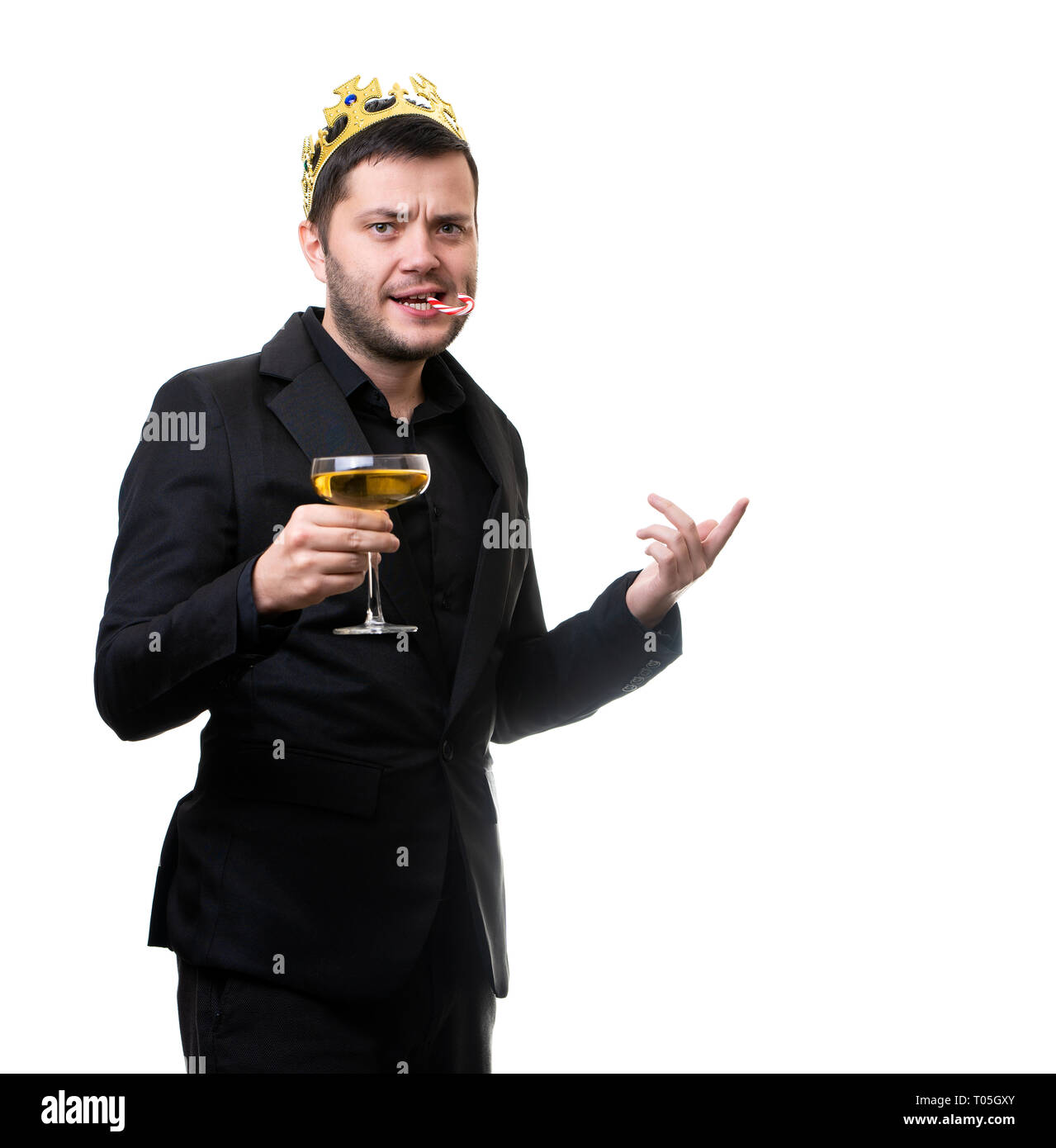 Happy brunet in crown, black suit with wine glass in hand. Stock Photo