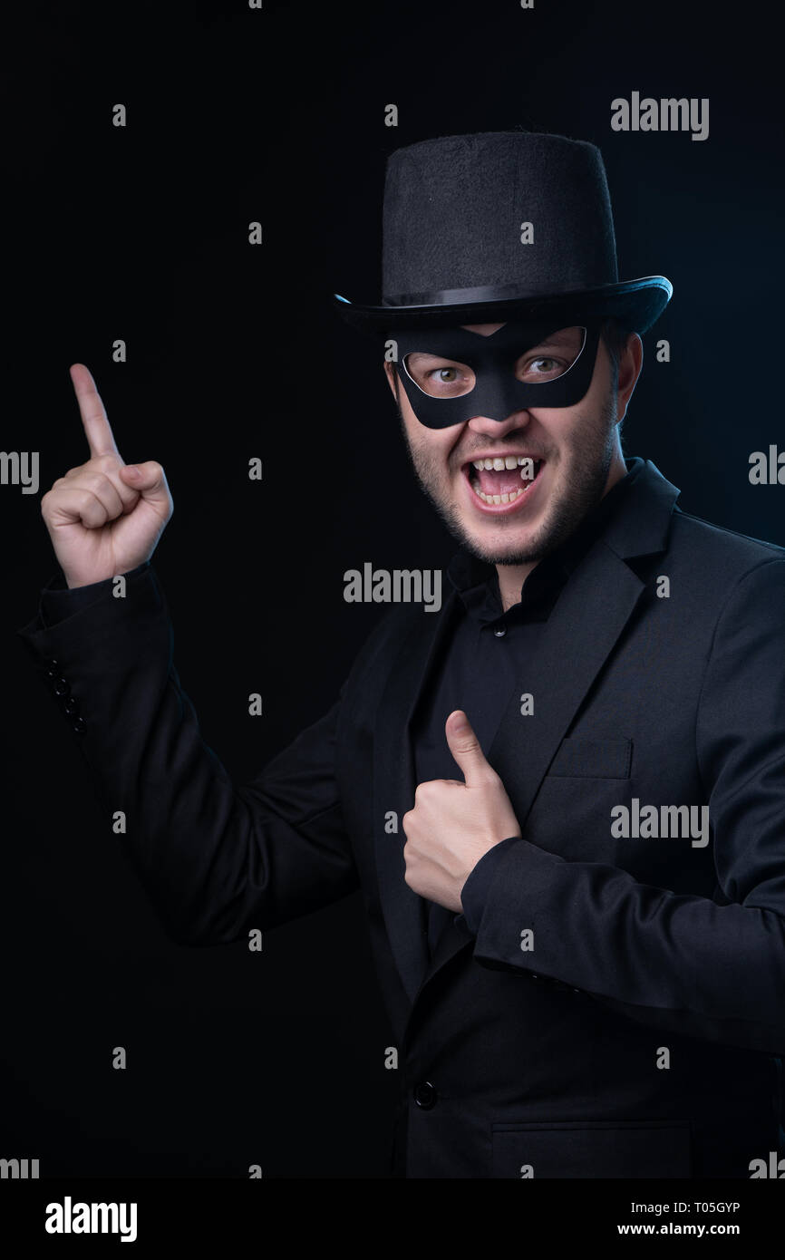 man in black mask, jacket,hat on empty black background Stock Photo Alamy