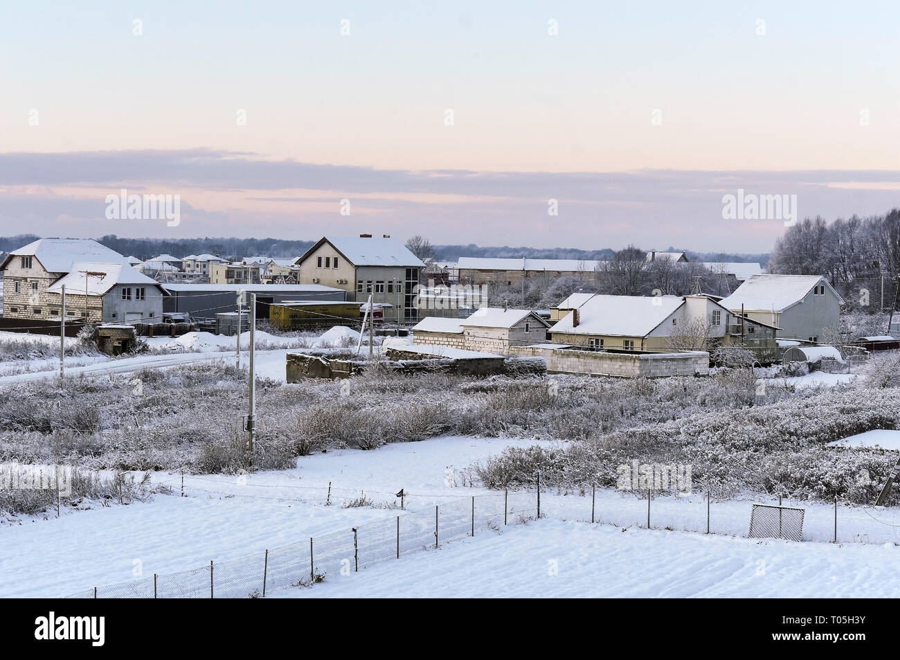 dawn in winter in the village, early frosty morning Stock Photo